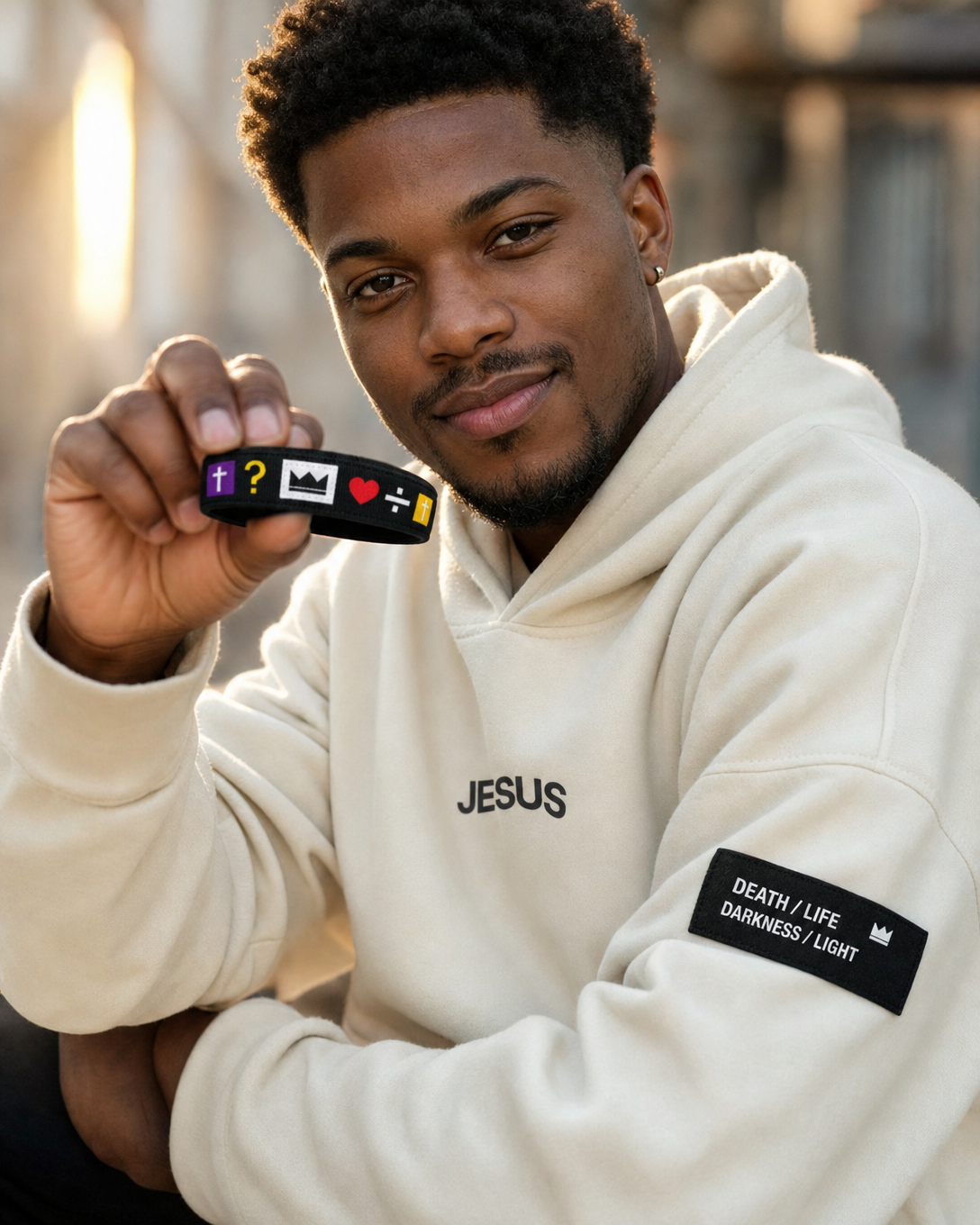 The Evangelist Bundle lifestyle - man wearing Jesus hoodie holding TAP gospel wristband
