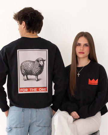 Two people wearing black sweatshirts with for the one lamb logo